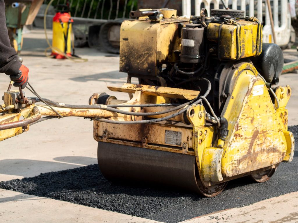 Close-up of a road roller in action during asphalt repair in Wrocław, Poland.